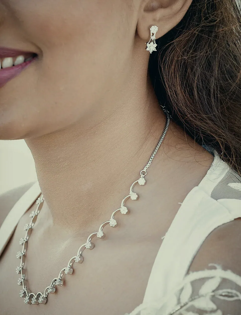 Devindi's smile and diamond necklace, close up