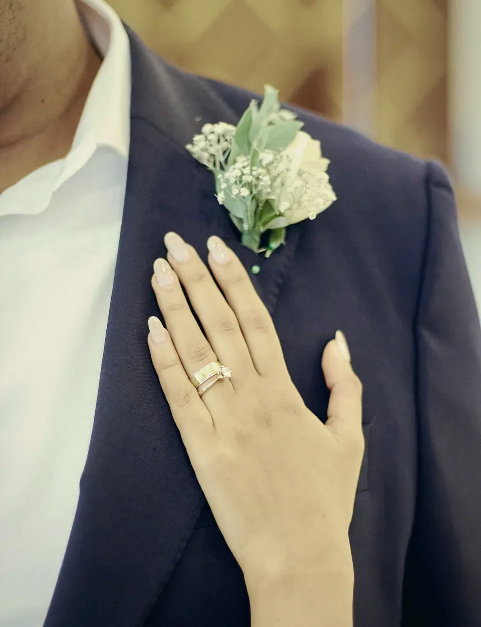Devindi's hand and ring on Hashindra's lapel and boutonniere