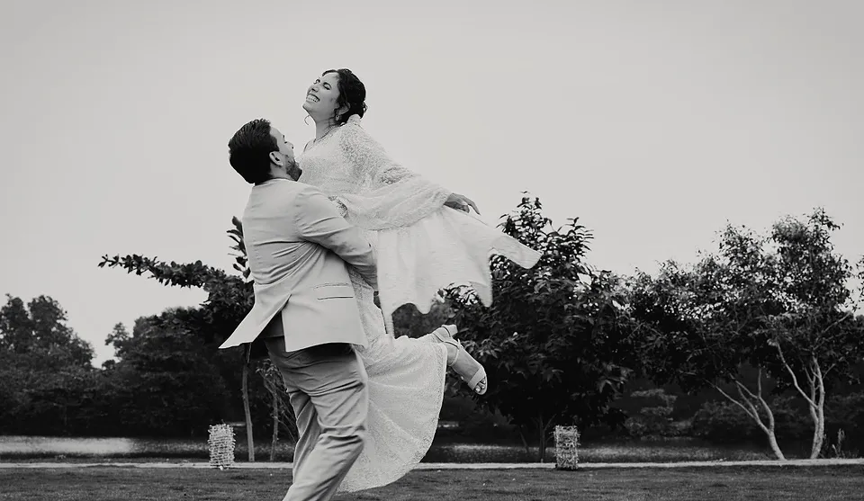 Dilshan lifting Maleesha into the air, in black and white