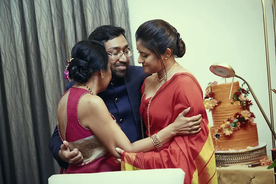 A laughing family embrace at a homecoming