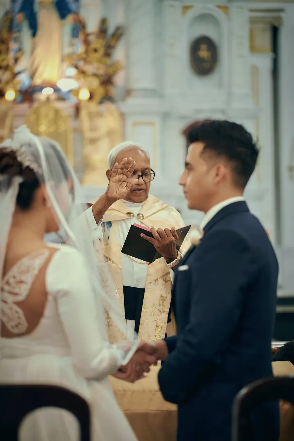 Stefney and Kevin exchanging vows at the altar