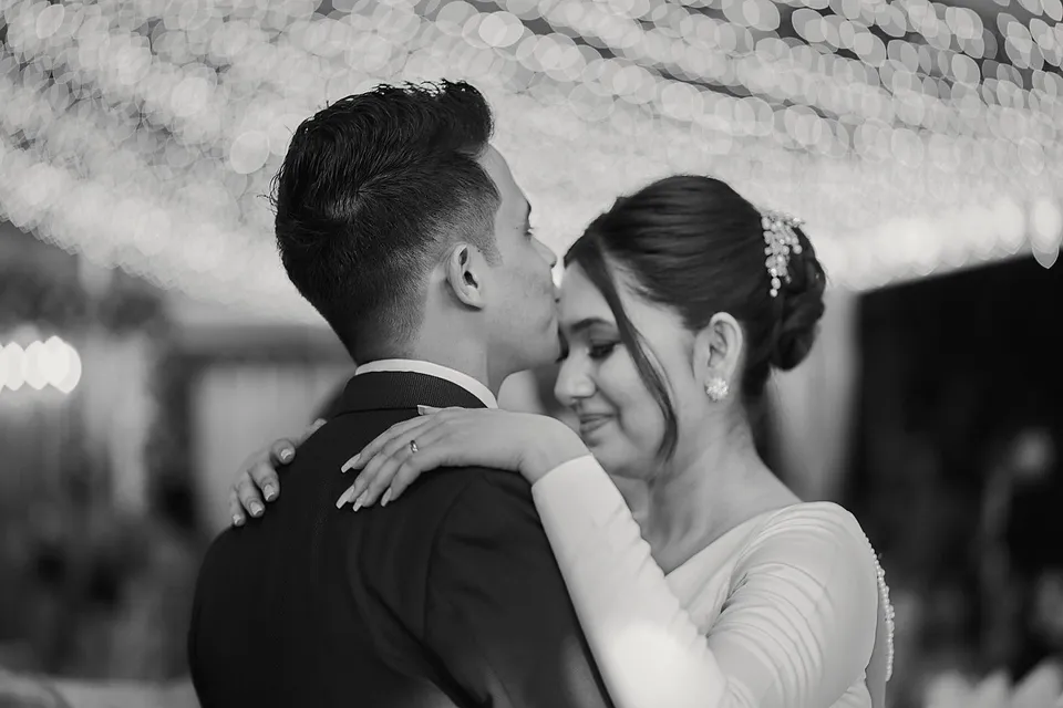 Stefney and Kevin cheek to cheek, in black and white