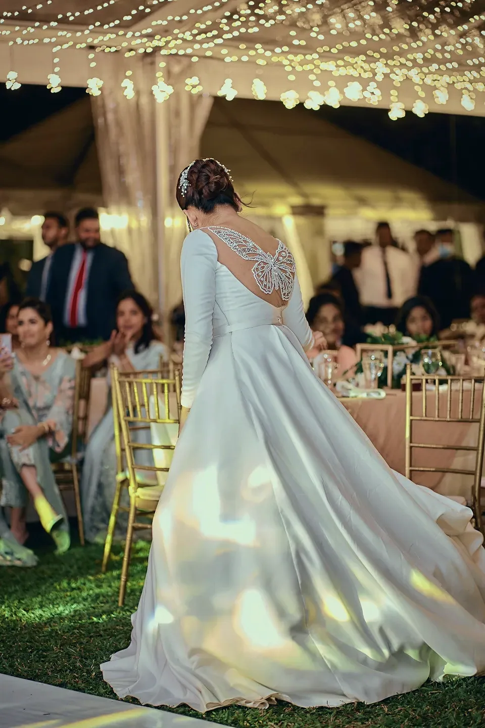 Stefney's gown sweeping across the lawn at the reception